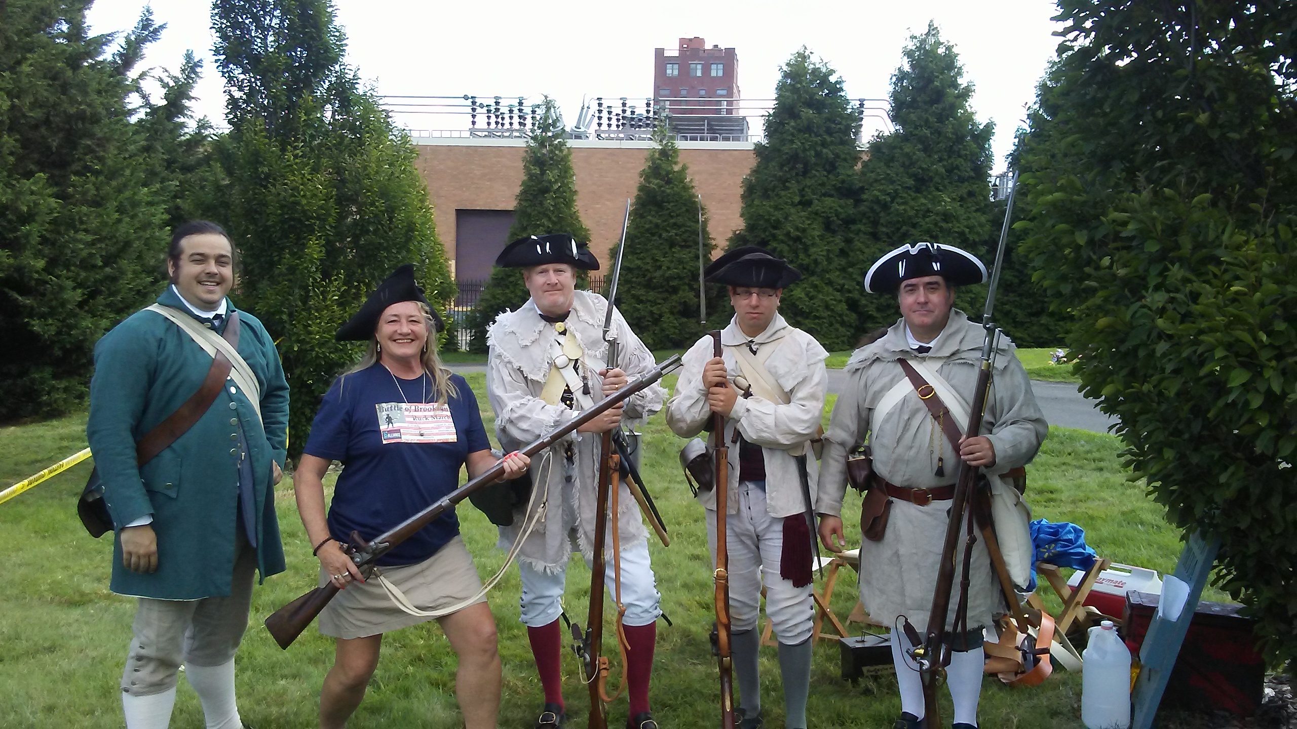 Angela Coyle shares smiles with Revolutionary War re-enactors as she coordinates the NYC Veterans Alliance Battle of Brooklyn Ruck March in 2019